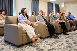 Group of seniors watching movie with popcorn