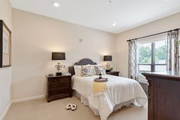 Bright bedroom with queen bed and nightstands