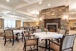 Elegant dining room with stone fireplace and tables