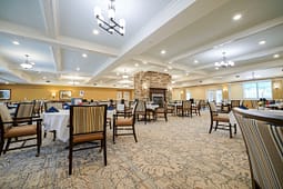Spacious dining hall with fireplace and chandeliers