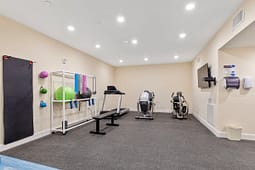 Small fitness room with treadmill and exercise equipment