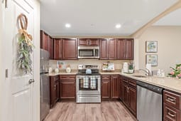 Modern kitchen with dark wood cabinets and stainless appliances