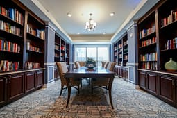 Elegant home library with table and built-in bookshelves