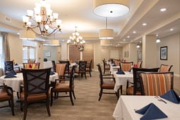 Elegant restaurant dining room with chandeliers and set tables