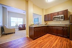 Modern kitchen with dark wood cabinets and granite counters