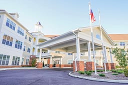 Senior living community entrance with American flag