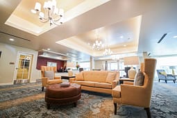 Elegant hotel lobby with beige seating and chandeliers