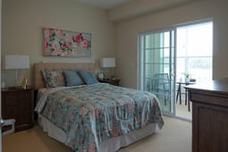 Cozy bedroom with floral bedding and balcony access