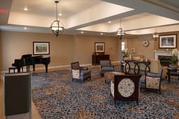 Elegant lounge with grand piano and fireplace
