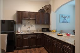 Modern kitchen with dark wood cabinets and granite countertops