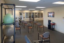 Physical therapy room with chairs and exercise equipment