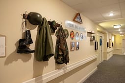 Military memorabilia displayed on hallway wall
