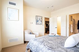 Modern bedroom with patterned bedspread and open doors