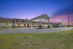 Senior living community building at sunset
