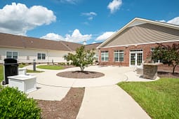 Landscaped courtyard with circular walkway and brick building