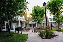 Apartment courtyard with patio seating and trees