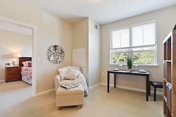Bright apartment living area with window and desk