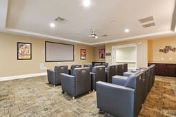 Small home theater with leather chairs and projector