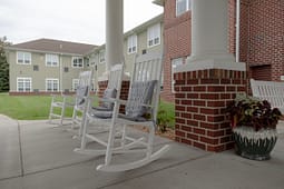 White rocking chairs on brick porch patio