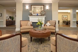Cozy lobby seating area with fireplace and armchairs
