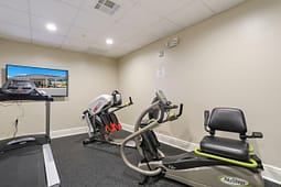 Small fitness room with treadmill and recumbent bike