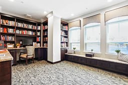 Cozy library room with bookshelves and window seating