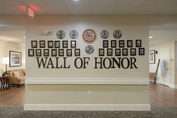 Wall of Honor with military portraits and emblems
