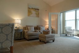 Cozy living room with armchairs and ottoman