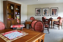 Game room with Scrabble board and wooden tables
