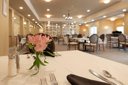 Elegant dining room table with pink flower centerpiece
