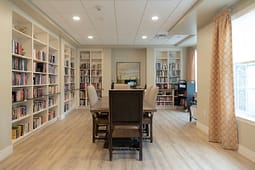 Cozy library room with bookshelves and wooden table