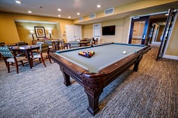 Recreation room with pool table and seating area