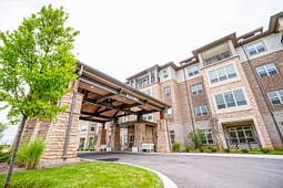 Modern apartment building with covered entrance and landscaping