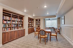 Cozy library room with bookshelves and table