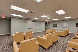 Small theater room with recliners and projector screen
