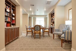 Cozy library room with table and bookshelves