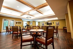 Spacious community dining room with piano and TV