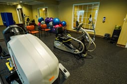 Small fitness room with exercise equipment and stability balls