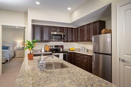 Modern kitchen with granite island and stainless appliances