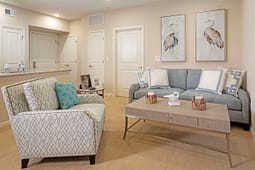 Modern living room with blue sofa and bird artwork