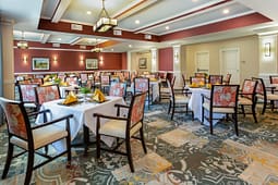 Elegant dining room with set tables and patterned chairs