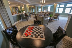 Checkers board on table in cozy lounge