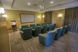 Small private theater room with projector and chairs