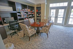 Cozy library study room with table and bookshelves