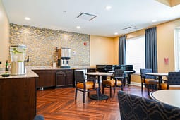 Cozy lounge with piano and small dining tables