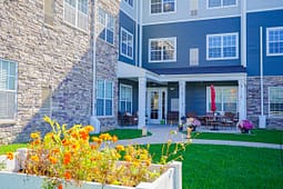 Apartment courtyard with patio seating and flowers