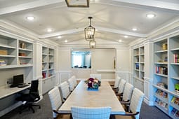 Elegant conference room with built-in bookshelves and long table