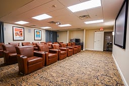 Private theater room with leather recliner seating