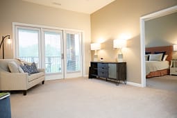 Bright living room with balcony and adjacent bedroom