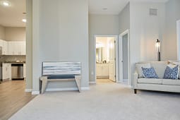 Modern apartment living room with kitchen and bathroom view